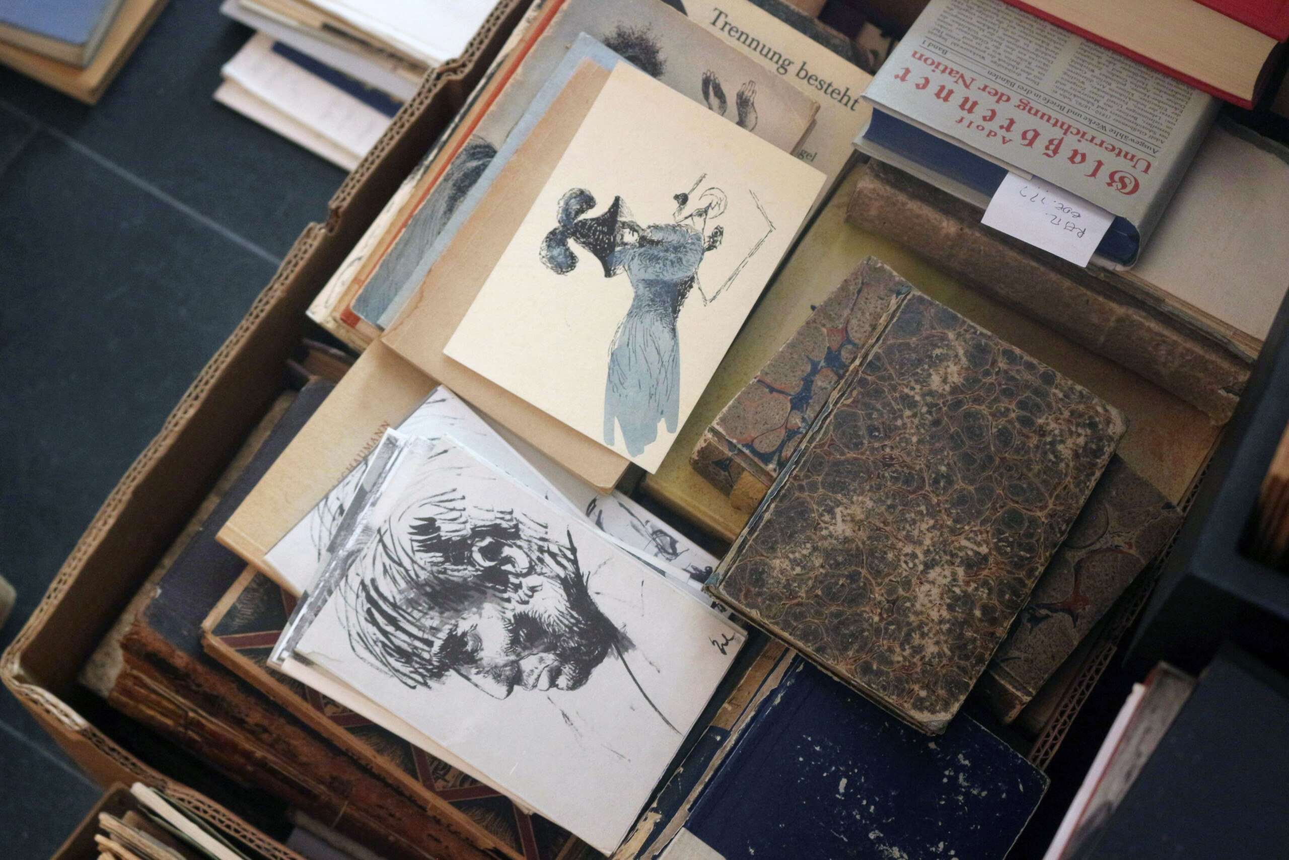 Some postcards and drawings in a box